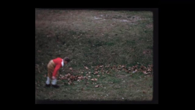 1959 7 year old Little boy in football uniform toss football