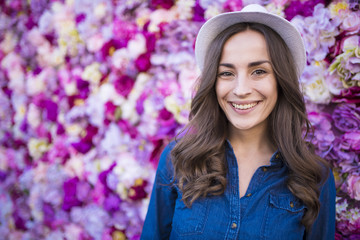 Smiling beautiful young woman with flower