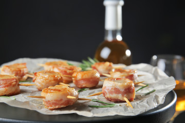 Stand with bacon wrapped scallops on dark background