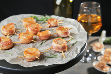 Stand with bacon wrapped scallops on table
