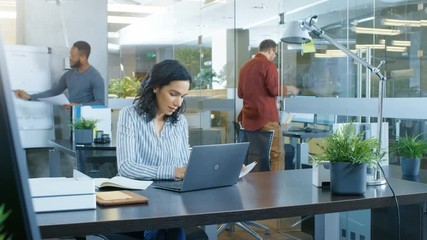 Time-Lapse of the Working Day of a Beautiful Hispanic Businesswoman. She Works in a Busy International Office where Diverse Team of Talented Young People. Shot on RED EPIC-W 8K Helium Cinema Camera. - Powered by Adobe