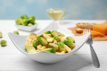 Plate of pasta with Brussels sprouts on table