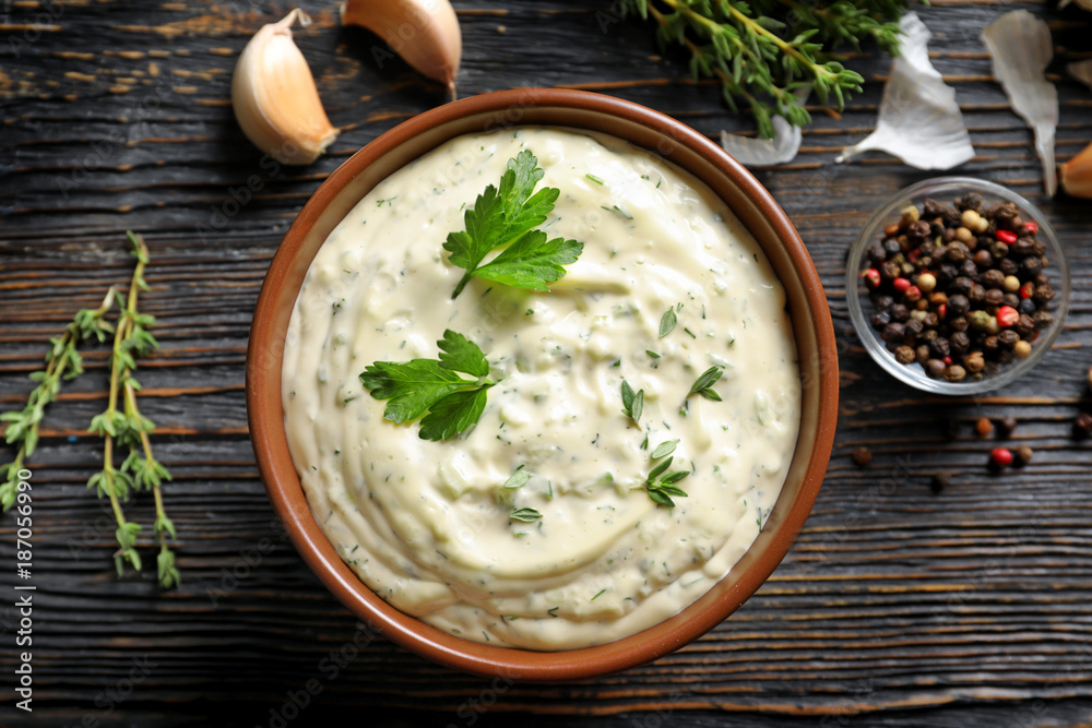 Canvas Prints tasty sauce with garlic in bowl on wooden table