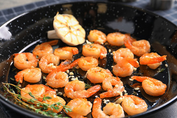 Dish with delicious fried shrimps and garlic, closeup