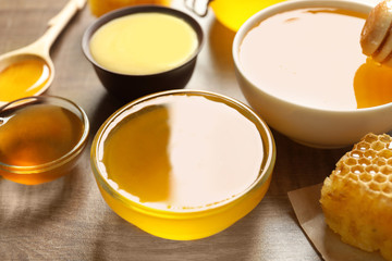 Bowls with delicious honey on table