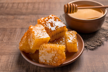 Plate with fresh honeycombs on table