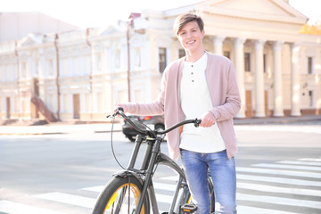 Obraz premium Hipster teenager with bicycle on crosswalk