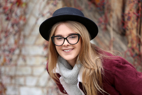 Attractive hipster girl in hat outdoors
