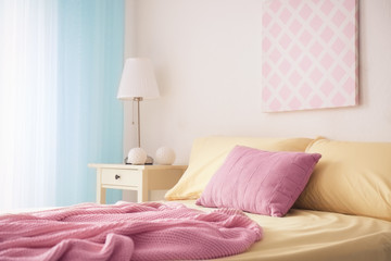 Comfortable bed with soft pillows indoors