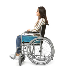Obraz na płótnie Canvas Young woman in wheelchair on white background