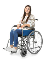 Young woman in wheelchair on white background