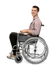 Young man in wheelchair on white background