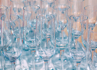 A lot of empty wine glasses. Close up at row of glasses prepare to service for dinner party
