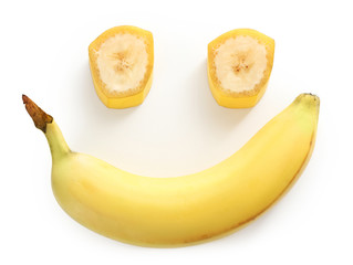 Smile made of bananas on white background