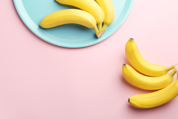 Composition with ripe bananas on color background © Africa Studio