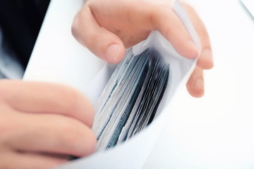 Fototapeta premium Man with bribe at table, closeup