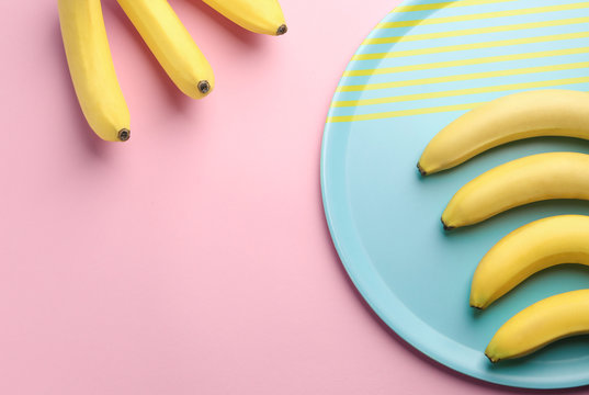 Composition with ripe bananas on color background
