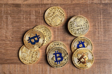Fototapeta na wymiar Golden bitcoins on wooden background