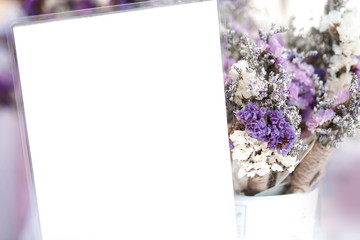 Empty white card and purple flower background.