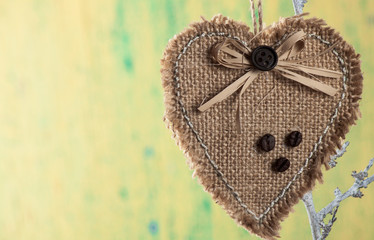 Heart from cloth on wood background