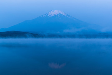 Fototapeta premium Mountain Fuji with morning mist in spring season at Lake Yamanakako