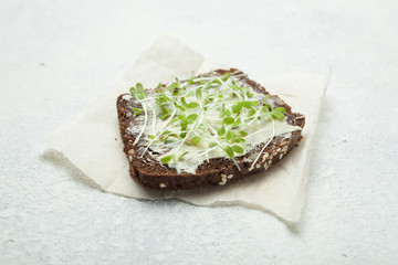 Live food from micro greens on whole grain bread. Raw food diet.