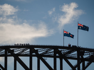 The Australian flag flies above the Sydney Harbour bridge in Australia.