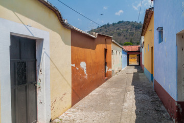 Narrow alley in Antigua Guatemala town, Guatemala.