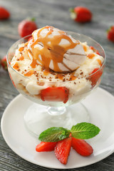 Bowl of yummy dessert with marshmallow and caramel on table