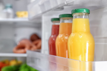 Different juices on shelf in refrigerator