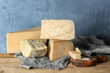 Different kinds of delicious cheese on table