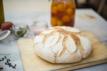 Freshly baked bread on a white rustic wooden table. Concept of healthy organic natural food.