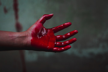 Halloween and horror concept. bloody hand in abandoned house. Photo with grain.