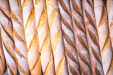 Freshly baked baguettes sprinkled with flour from above.