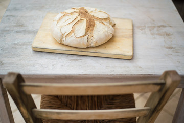 Freshly baked bread on a white rustic wooden table. Concept of healthy organic natural food.