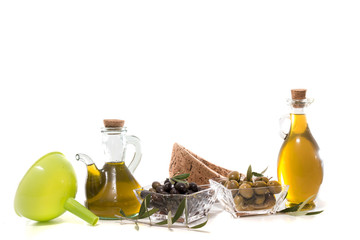 Green and black olives with olive oil bottles