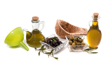 Green and black olives with olive oil bottles