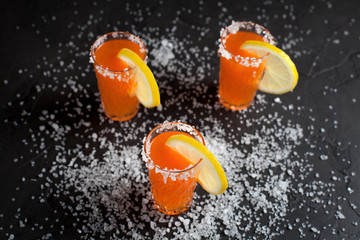 orange cocktails, salt, lemon on a dark background