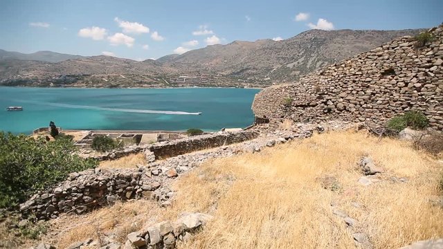 Ruins of an ancient fortress on the island of Spinalonga against the background of the sea and sky. Cretan island of Spinalonga, Crete. Greece