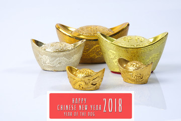 Fototapeta premium Chinese new year festival decorations, gold ingots isolated on white. Chinese characters means luck,wealth and prosperity. HAPPPY CHINESE NEW YEAR 2018