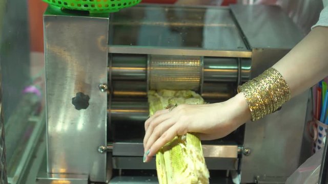 The woman cooks reed drinks. Vietnamese night market. The woman cooks reed drinks. Sugar..