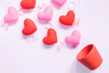 Top view of flat lay mockup with romantic decoration Romantic, St valentine's day concept with valentines mini pin heart on pot pink background with copy space minimal style.
