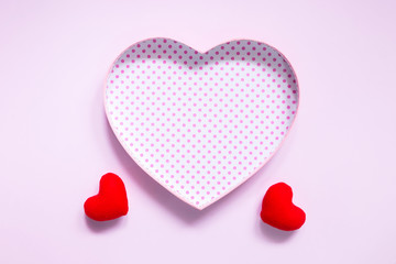 Top view of flat lay mockup with romantic decoration Romantic, St valentine's day concept with valentines mini pin heart on pink background with copy space minimal style.