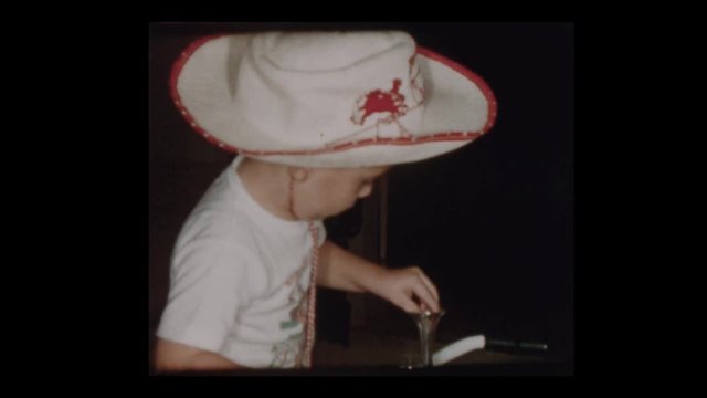 1955 Adorable little boy wearing cowboy hat