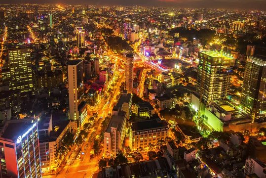 HO CHI MINH CITY, VIETNAM – MAY, 2016 : Timelapse of central cityscape at night with traffic and  tall buildings in view