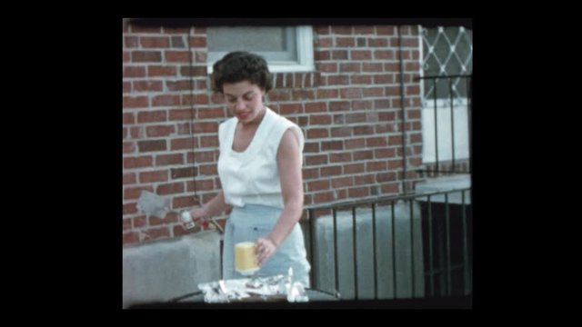 1955 50's Mom grills burgers on BBQ