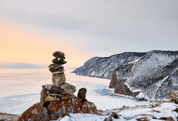 Pyramid of stones above ice lake