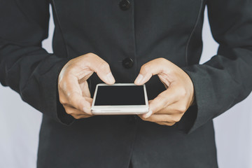 business man standing with smart phone in hand, modern technology with people concept background 