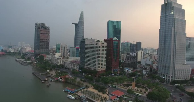 HO CHI MINH CITY, VIETNAM – MAY, 2016 : Aerial shot of central Ho Chi Minh with skyscrapers, boats and saigon river in view
