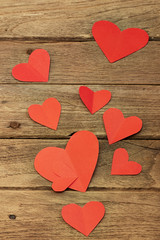 Red heart paper on wooden background